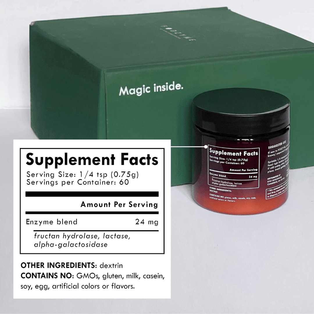 FODZYME enzyme powder jar next to green FODZYME shipping box reading 'Magic inside.' Supplement facts panel shows: Serving Size 1/4 tsp (0.75g), 60 servings per container, Enzyme blend 24mg (fructan hydrolase, lactase, alpha-galactosidase). Other ingredients: dextrin. Contains no GMOs, gluten, milk, casein, soy, egg, artificial colors or flavors.
